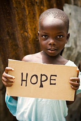 Child holding a sign of hope